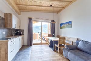 a kitchen and living room with a couch and a table at Frühaufhof in Barbiano