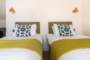 A bed or beds in a room at The Old School House B&B