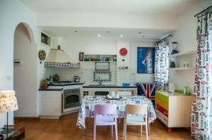 a kitchen with a table and chairs in it at Mediterraneo Guesthouse in Giardini Naxos