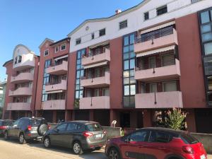 a group of cars parked in front of a building at Residence Viale del Sole in Grado