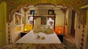 a bedroom with a large bed in a room at Jewel Palace Haweli in Jodhpur