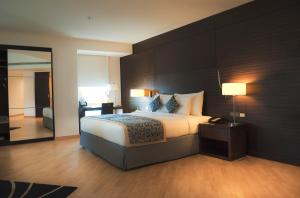 a bedroom with a large bed and a mirror at Asdal Boutique Hotel Seef in Manama +82 photos