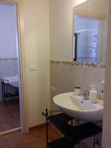 a bathroom with a white sink and a mirror at Agriturismo Annarella in Carassai +28 photos