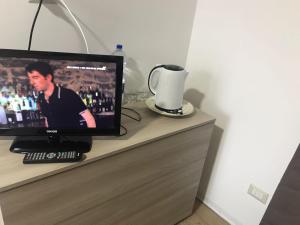 a television sitting on top of a dresser at Luxury Suite terrazze e vista mare in Taormina