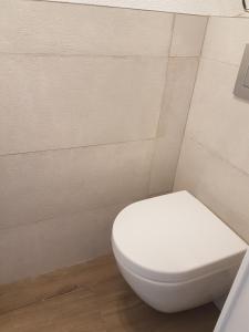 uma casa de banho com um WC branco num quarto em Maison Princesse em Port Leucate