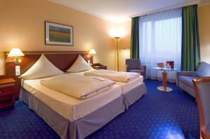 Postel nebo postele na pokoji v ubytování Mercure Hotel Trier Porta Nigra