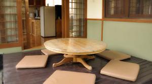a wooden table and chairs in a room at Villa Kota Bunga Ade Type Jepang - 0228 in Cibadak