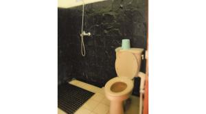 a bathroom with a toilet and a shower at Villa Kota Bunga Ade Type Jepang - 0228 in Cibadak +6 photos