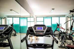a gym with two treadmills and exercise bikes at Apartamentos Fernando de los Rios in Granada