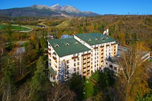 an aerial view of a building with a green roof at Hotel Slovan in Vysoke Tatry - Tatranska Lomnica.