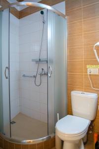 a bathroom with a glass shower with a toilet at Guest House on Lermontova 8 in Sochi