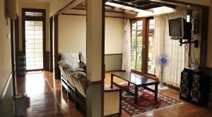 a living room with a couch and a tv at Villa Kota Bunga Ade Type Jepang - 0222 in Cibadak