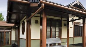 a building with a bench in front of it at Villa Kota Bunga Ade Type Jepang - 0222 in Cibadak