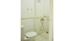 a bathroom with a toilet and a shower at Villa Kota Bunga Ade Type Jepang - 0222 in Cibadak +8 photos