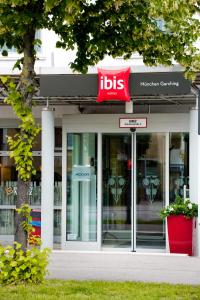 a store with a sign on the front of a building at ibis Hotel München Garching in Garching bei München