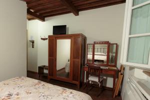 a bedroom with a mirror and a bed and a desk at Hotel Giuly in Torre del Lago Puccini