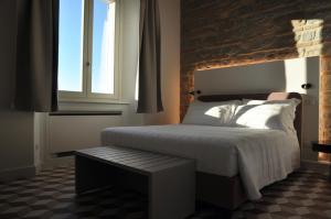a bedroom with a large bed and a window at Al Foro Annonario in Senigallia