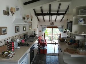 a kitchen with a sink and a counter top at Quinta do Bom Vento in Óbidos