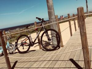 a bike parked on a boardwalk near the beach at Douro Marina Studios in Vila Nova de Gaia