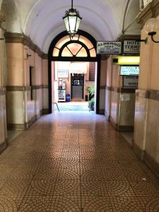 an empty hallway in a building with an archway at Hotel Termini in Rome