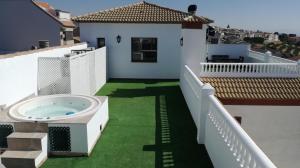 a balcony with a hot tub on top of a house at Alojamiento Rural La Fabrica in Sabiote