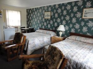 מיטה או מיטות בחדר ב-Hipwell's Motel