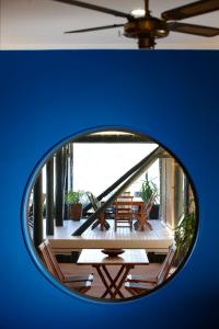 a round mirror with a view of a deck at Tipi and Bobs Waterfront Lodge in Tryphena