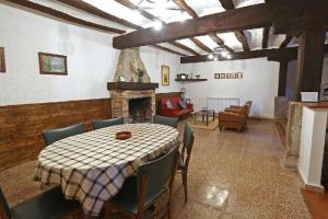 a dining room with a table and a fireplace at Casa Rural Jaxo in Atondo
