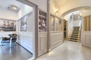 a hallway with a staircase and a door with a chair at Hotel Galija in Pula