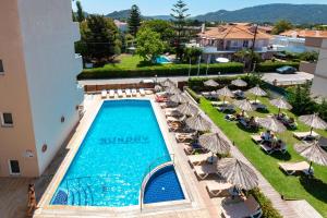 an overhead view of a swimming pool with chairs and umbrellas at Sunday Hotel in Ialyssos
