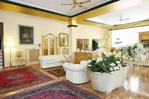 a large living room with white furniture and a ceiling at Hotel Villa Luisa in Rapallo