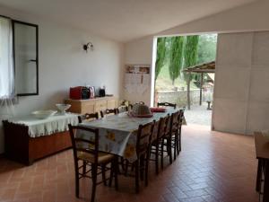 a dining room with a table and some chairs at Agriturismo Podere Bellosguardo in Villamagna