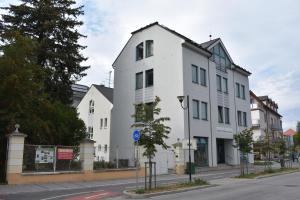 a white building on the side of a street at Apartment Bertík in Třeboň
