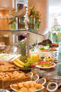 a buffet with many different types of food on a table at Sunday Hotel Dortmund City in Dortmund
