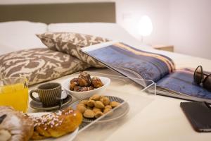 Säng eller sängar i ett rum på Palermo In Suite Aparthotel