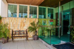 a bench sitting outside of a building with windows at Fortpraia Hotel in Fortaleza
