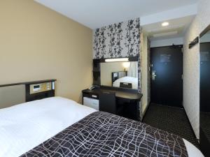 Ένα ή περισσότερα κρεβάτια σε δωμάτιο στο APA Hotel Nagoya Sakae Kita