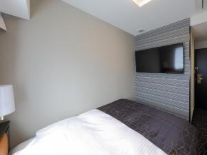 Ένα ή περισσότερα κρεβάτια σε δωμάτιο στο APA Hotel Nagoya Sakae Kita
