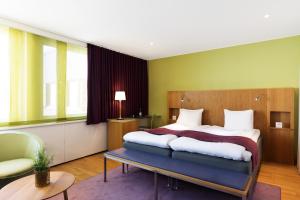 Una cama o camas en una habitación de ProfilHotels Aveny