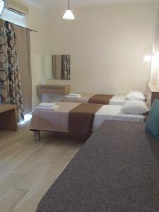 A bed or beds in a room at Angelica Studios and Apartments