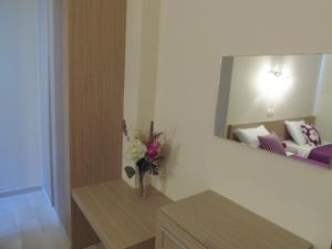 A bed or beds in a room at Angelica Studios and Apartments