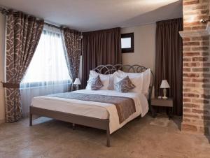 a bedroom with a large bed and a window at Hotel Azimut in Sveti Stefan +33 photos