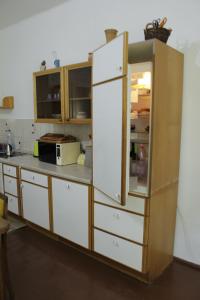 a kitchen with a large white refrigerator and cabinets at Hársfák in Mezőkovácsháza