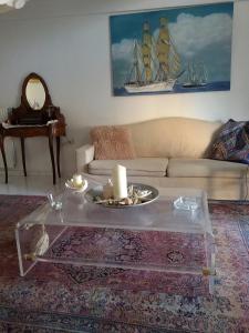 ein Wohnzimmer mit einem Sofa und einem Couchtisch in der Unterkunft Sea & City - 10 min drive to the beach & Athens Airport in Markopoulo