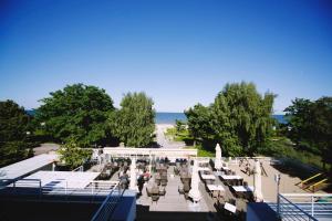 a view of a park with benches and the ocean at Hotel Pomarańczowa Plaża ex Bursztyn in Sopot