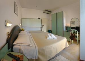 a bedroom with a bed with two towels on it at Hotel Cavalluccio Marino in Gabicce Mare +92 photos