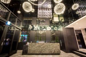 a lobby of a building with chandeliers at Sun Hao Hotel Taichung in Taichung