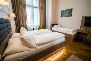 
מיטה או מיטות בחדר ב-Hotel Marc Aurel
