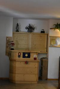 a large wooden cabinet in a room at Albergo Mangusta in Madesimo