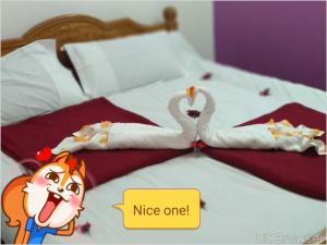 two swans made out of napkins on a bed at Breezy Land Residency (Nidhi Sri & k.k resort) in Yercaud